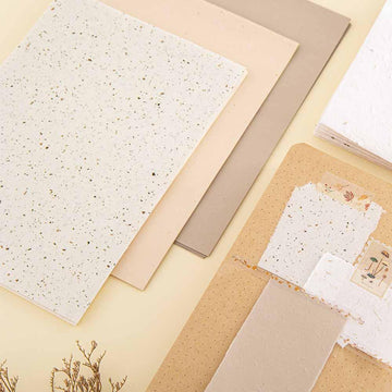 Close up of Tsuki Mixed Scrapbook Paper Pack with open Tsuki Kraft Paper Limited Edition Bullet Journal on cream background